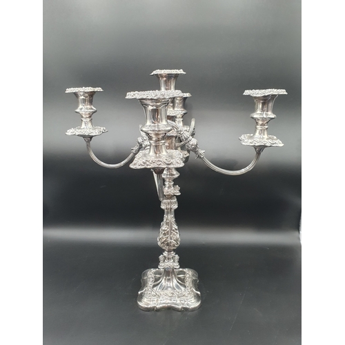 141 - A plated Candelabra with floral decorated bulbous stem on shaped square base, the surmount with four... 