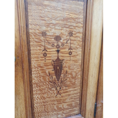 263 - A Victorian ash and satinwood Wardrobe with urn and swag inlay, fitted pair of mirror doors flanking... 