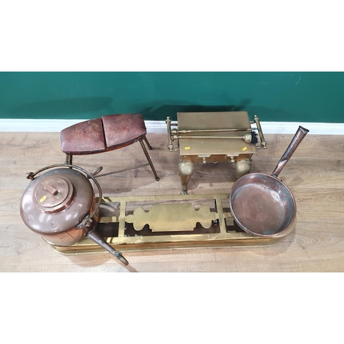 266 - A brass Fender 4ft Long, a brass Footman, a copper Kettle with swing handle and tap, a copper Huntin... 