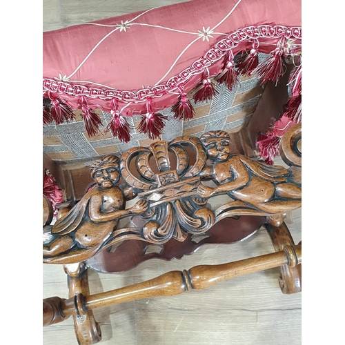 273 - A red upholstered Footstool on leafage carved scroll supports 1ft 9in W x 1ft 6in H (R10)