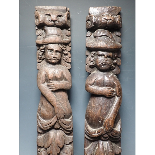 278 - A near pair of 17th Century oak Caryatids with carved figure and fruiting vine designs, 2ft 2