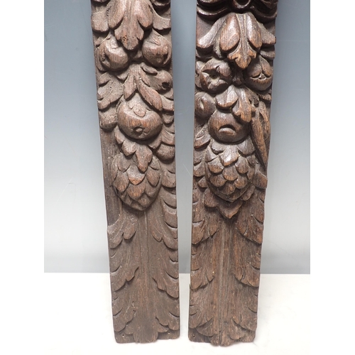 278 - A near pair of 17th Century oak Caryatids with carved figure and fruiting vine designs, 2ft 2