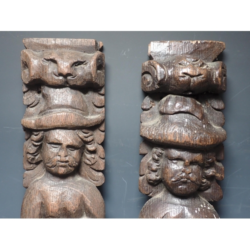 278 - A near pair of 17th Century oak Caryatids with carved figure and fruiting vine designs, 2ft 2