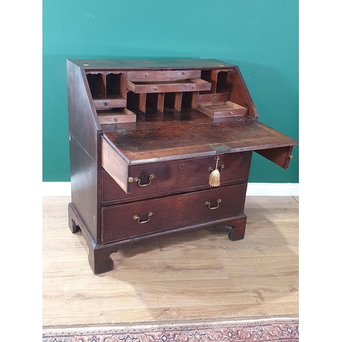 33 - A Georgian oak Bureau fitted two short and two long drawers raised on ogee bracket feet 3ft 4in H x ... 