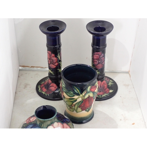 348 - A group of Moorcroft items including a pair of Candlestick, two Vases, a covered Bowl