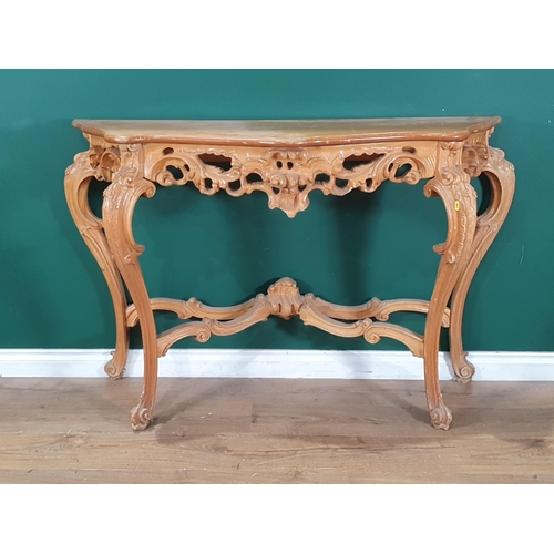 397 - A reproduction Console Table with shaped top, above carved frieze, on shaped and splayed supports un... 