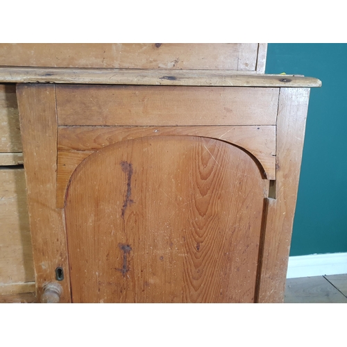 495 - A Victorian pine Dresser with glazed upper section above base fitted pair of arched panel doors flan... 