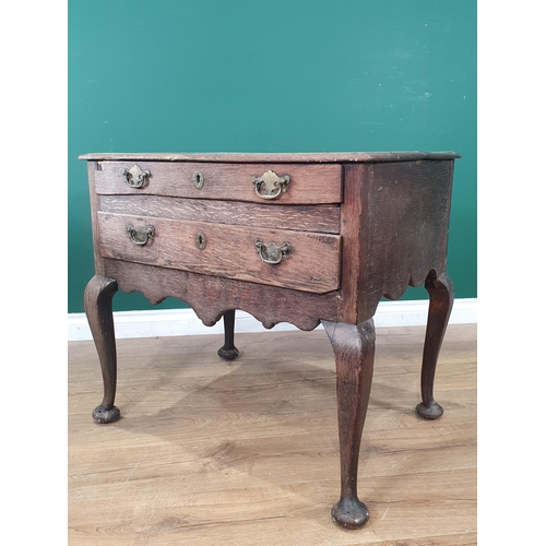 507 - An 18th Century oak Lowboy with moulded two plank top above two long drawers with shaped apron mount... 