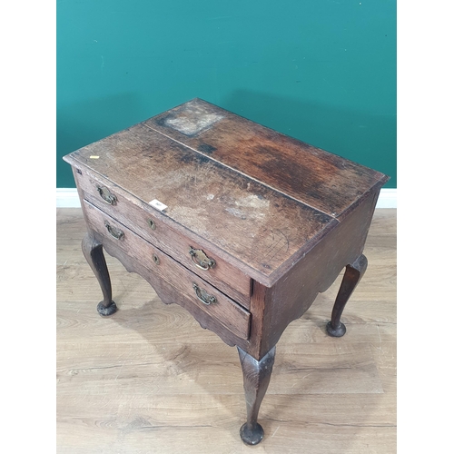 507 - An 18th Century oak Lowboy with moulded two plank top above two long drawers with shaped apron mount... 