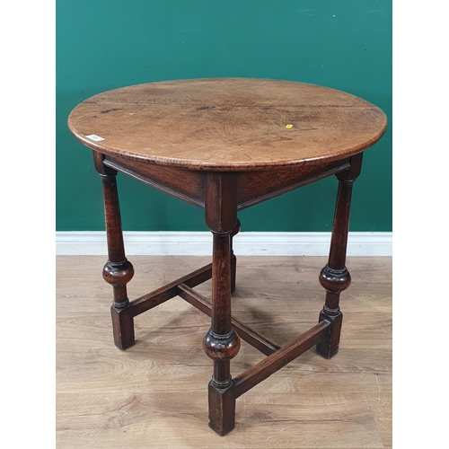 523 - A circular oak Occasional Table on turned column and ball supports united by H-stretcher 2ft 6in D x... 