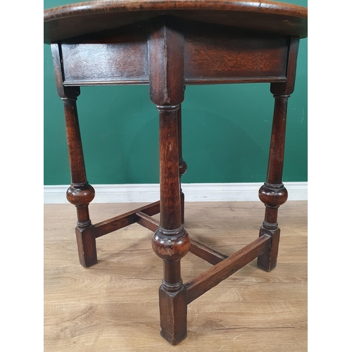 523 - A circular oak Occasional Table on turned column and ball supports united by H-stretcher 2ft 6in D x... 