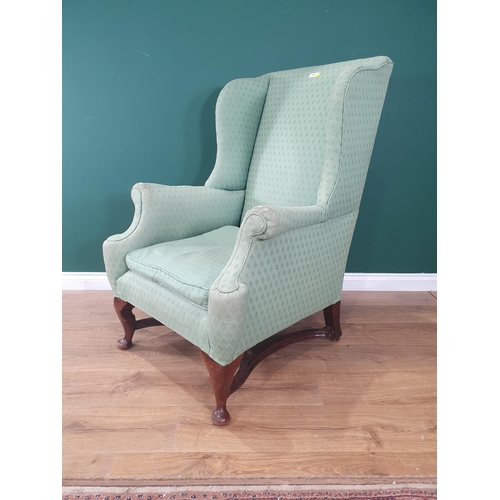 557 - An antique green upholstered wing back Armchair on cabriole front supports 3ft 8in H x 2ft 6in W (R6... 