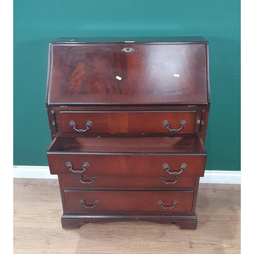 571 - A reproduction mahogany Bureau, the fall front enclosing pigeon hole and drawer interior and inset w... 