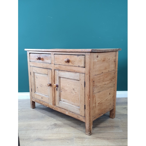 646 - A rustic pine Cupboard fitted pair of drawers over pair of panelled doors, raised on square supports... 