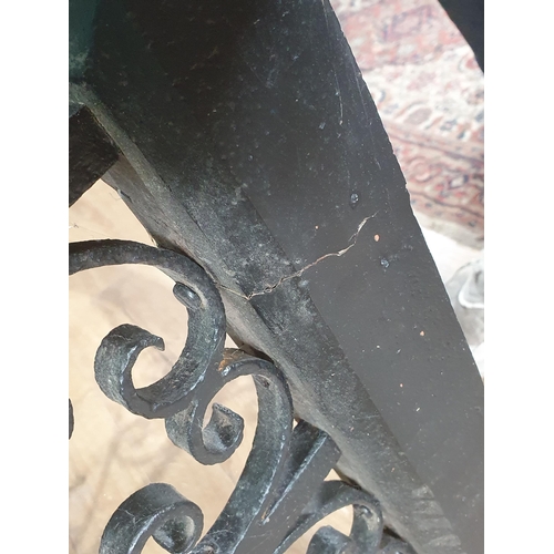 655 - A cast iron and oak Club Fender with scrolled and twisted designs A/F (split to one corner), 1ft 7