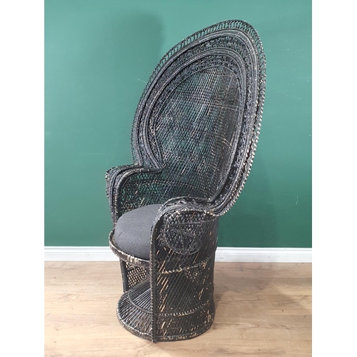 660 - A black painted wicker Peacock Chair, 4ft 10