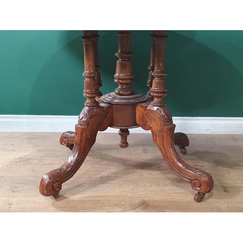 665 - A Victorian oval tilt top Breakfast Table, the top with flowering urn designs, raised on turned colu... 