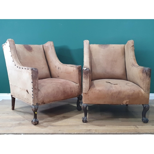 667 - A pair of Georgian style leather upholstered Easy Chairs on carved claw and ball supports, A/F. (R9)... 