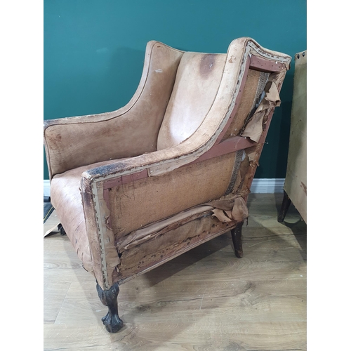 667 - A pair of Georgian style leather upholstered Easy Chairs on carved claw and ball supports, A/F. (R9)... 