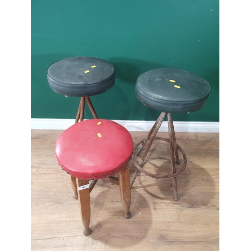 668 - A pair of green upholstered Industrial Stools, and another red upholstered Stool. (R8).