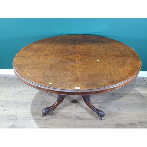 678 - An oval walnut Tilt Top Breakfast Table on turned column and carved quadruple base and castors, 2ft ... 