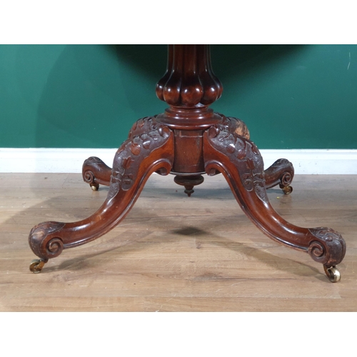 678 - An oval walnut Tilt Top Breakfast Table on turned column and carved quadruple base and castors, 2ft ... 