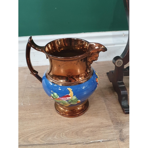 701 - An oval Dressing Mirror and a pair of copper lustre Jugs with moulded design