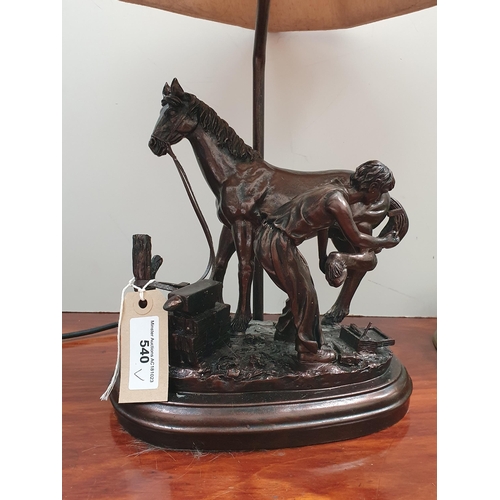 540 - A bronze effect figural Table Lamp of a blacksmith shoeing a horse with fabric shade 1ft 8in H and a... 