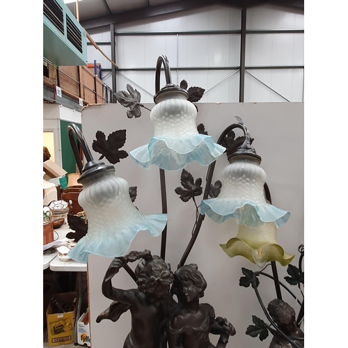 572 - Two bronze effect Table Lamps with figural design of cherubs and maidens with glass shades 2ft 10in ... 