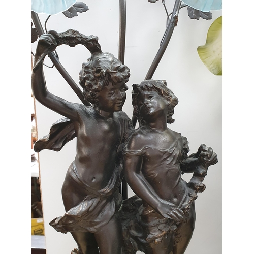 572 - Two bronze effect Table Lamps with figural design of cherubs and maidens with glass shades 2ft 10in ... 