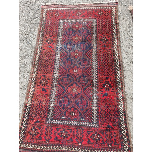 451 - Two red ground woollen Rugs with geometric designs 5ft 4in L x 3ft W and 4ft 8in L x 2ft 9in W (R4)