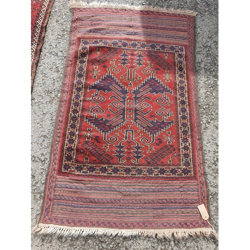 451 - Two red ground woollen Rugs with geometric designs 5ft 4in L x 3ft W and 4ft 8in L x 2ft 9in W (R4)