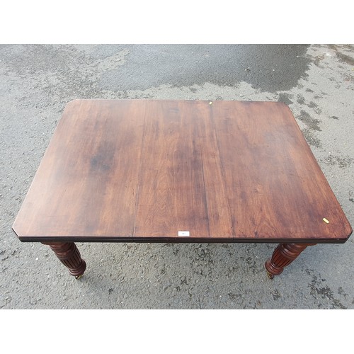 449 - A late 19th Century walnut extending Dining Table on turned supports and casters