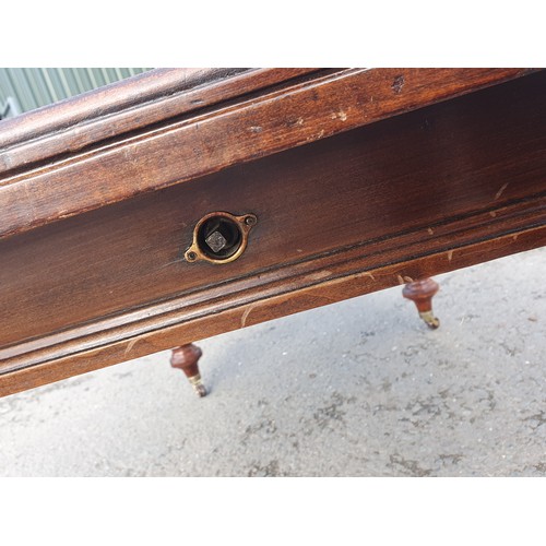 449 - A late 19th Century walnut extending Dining Table on turned supports and casters