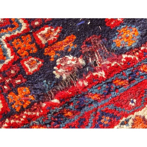 217 - Two Persian Rugs with lozenge designs on red grounds, 8ft 5in x 5ft 6in and 9ft 2in x 6ft 9in A/F