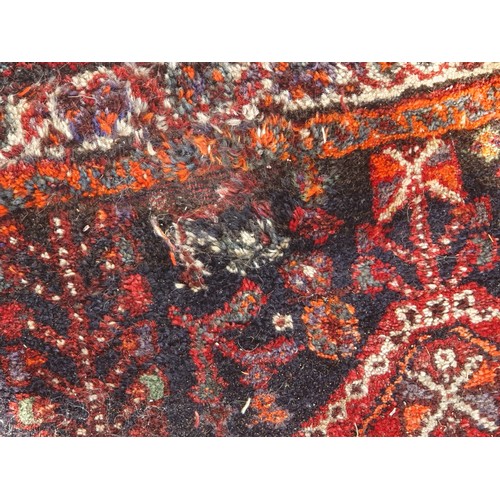 217 - Two Persian Rugs with lozenge designs on red grounds, 8ft 5in x 5ft 6in and 9ft 2in x 6ft 9in A/F