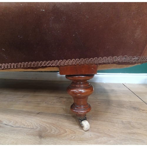 566 - A Victorian Chaise Longue with brown upholstery mounted on turned supports and ceramic casters 6ft 6... 