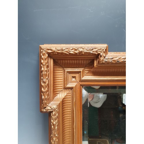 565 - A gilt Empire style Wall Mirror with shaped rectangular frame and bevelled plate, 19 x 16in (R6)