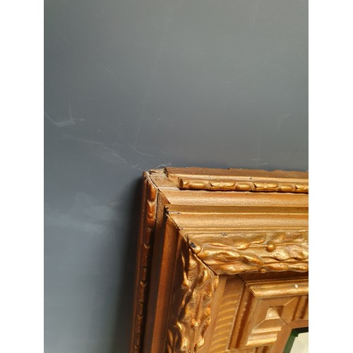 565 - A gilt Empire style Wall Mirror with shaped rectangular frame and bevelled plate, 19 x 16in (R6)