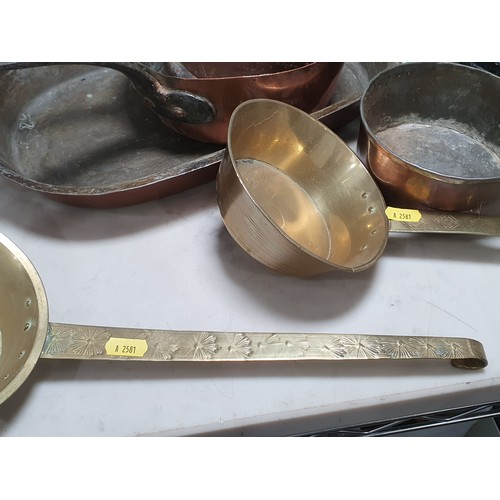 688 - An antique two handled Cooking Pot, two brass Pans with geometric pattern handles, a copper two hand... 