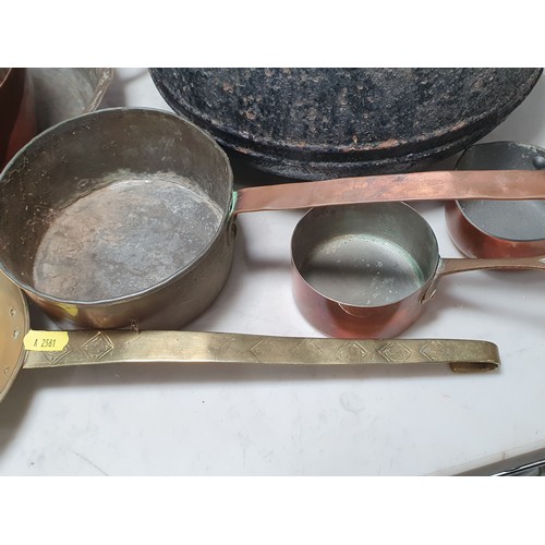 688 - An antique two handled Cooking Pot, two brass Pans with geometric pattern handles, a copper two hand... 