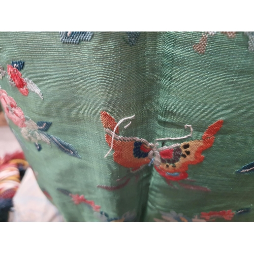 214 - A green Chinese Robe embroidered butterflies and flowers with gilt buttons. (R5)