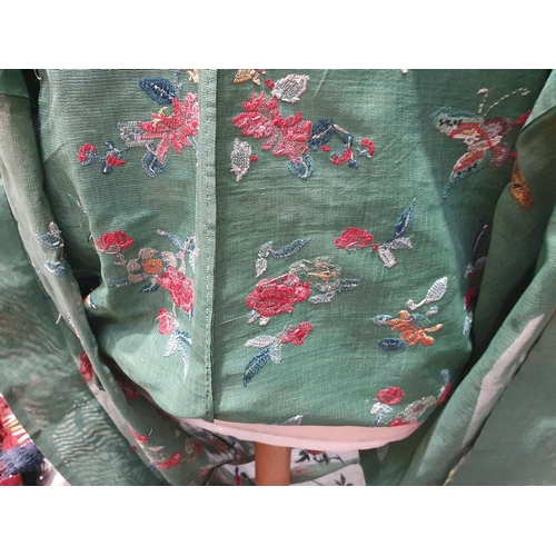 214 - A green Chinese Robe embroidered butterflies and flowers with gilt buttons. (R5)