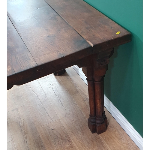 917 - An oak Library Table with five plank top raised on cluster column supports 3ft 9in W x 2ft 5in H (R4... 