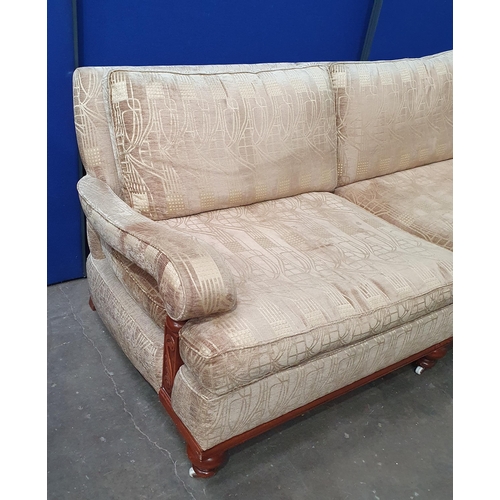 840 - An upholstered Settee with scrolled arms, gold upholstery and raised on turned supports, 7ft W x 3t ... 