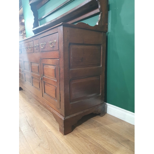 761 - An 18th Century oak Dresser and Rack, rack with shaped sides, base fitted five drawers with two fiel... 