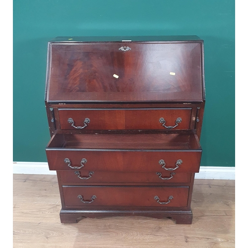 27 - A reproduction mahogany Bureau, the fall front enclosing pigeon hole and drawer interior and inset w... 