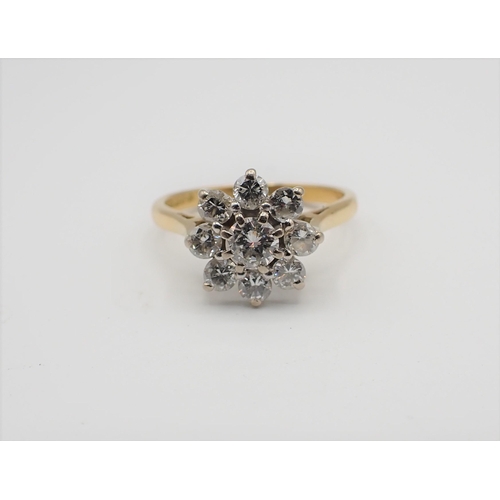 167 - A Diamond flower Cluster Ring claw-set brilliant-cut stone within frame of eight smaller stones in 1... 