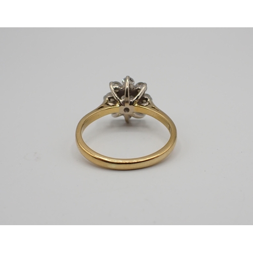167 - A Diamond flower Cluster Ring claw-set brilliant-cut stone within frame of eight smaller stones in 1... 