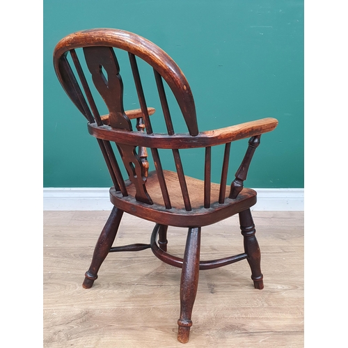 693 - A 19th Century child's ash back Windsor Elbow Chair with pierced splat back on baluster turned suppo... 